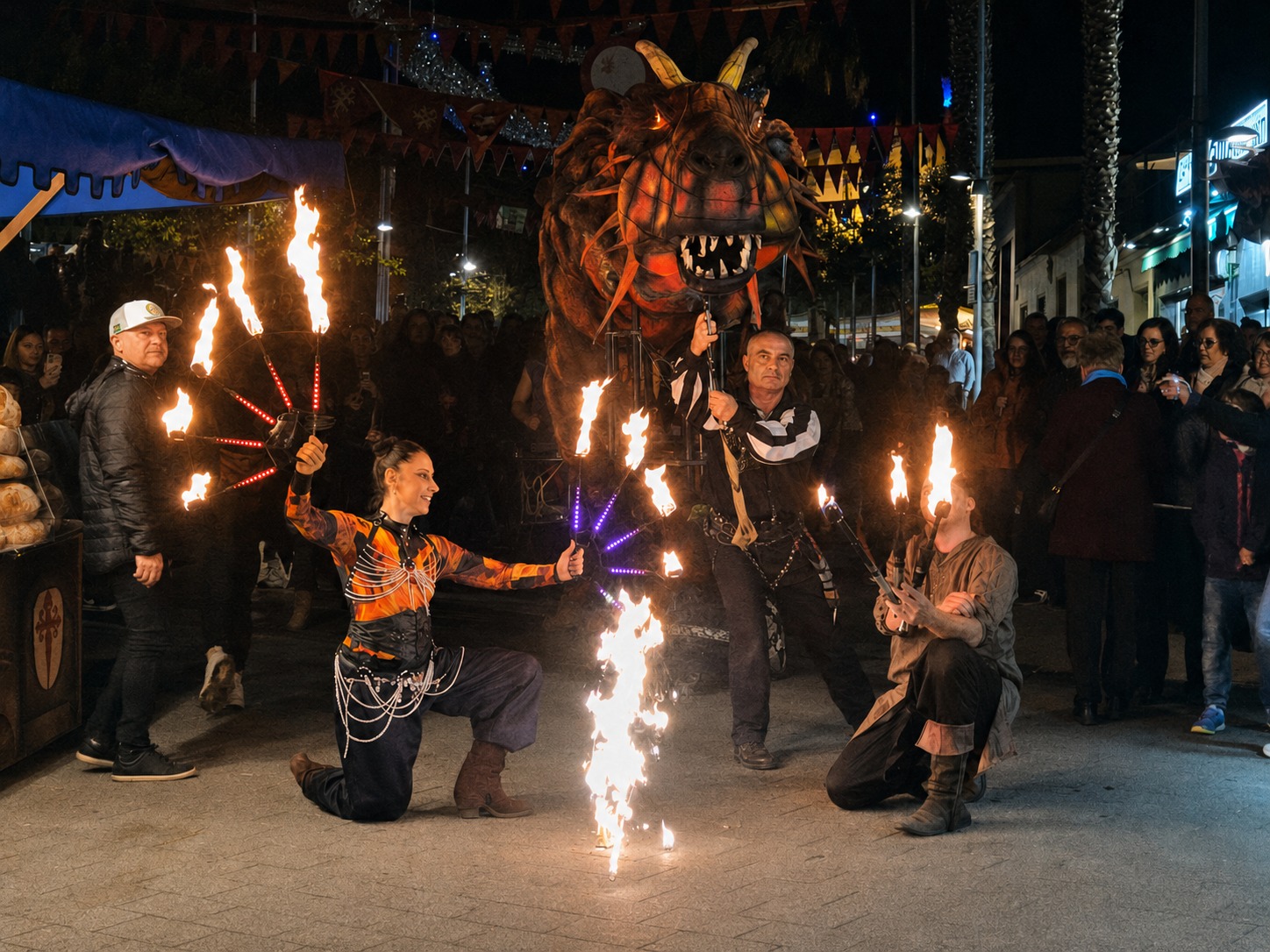 El Dragón Rojo acompañado por artistas de fuego durante el pasacalles nocturno